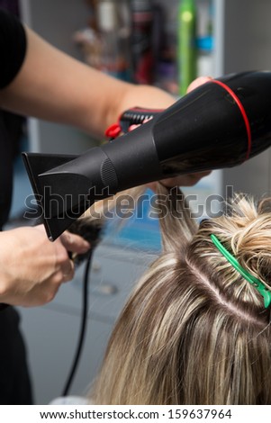 drying with a hair dryer in the barbershop