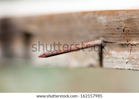 rusty nail in piece of wood