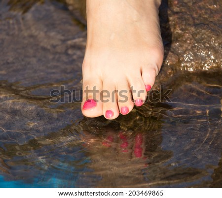 pedicure on foot in the water on the rocks