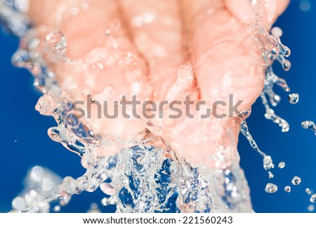 hand in the water on a blue background
