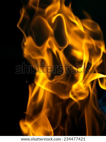 face on fire on a black background