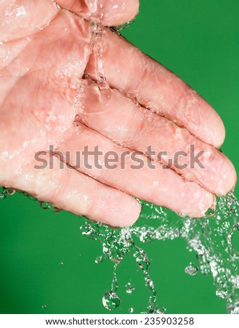 hand in the water on a green background