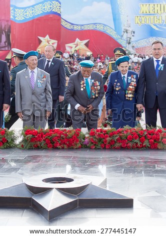 SHYMKENT city, KAZAKHSTAN MAY 9, 2015: Laying flowers at the Eternal Fire, Victory Day, in memory of the soldiers of the Great Patriotic War.  Shymkent, Kazakhstan May 9, 2015