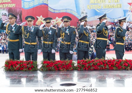 SHYMKENT city, KAZAKHSTAN MAY 9, 2015: Laying flowers at the Eternal Fire, Victory Day, in memory of the soldiers of the Great Patriotic War.