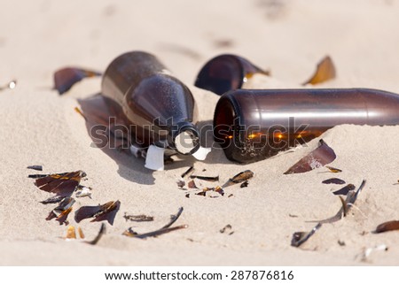 Glass bottles in the sand on nature. trash