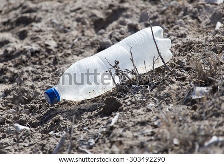 plastic bottle in the sand on nature. trash