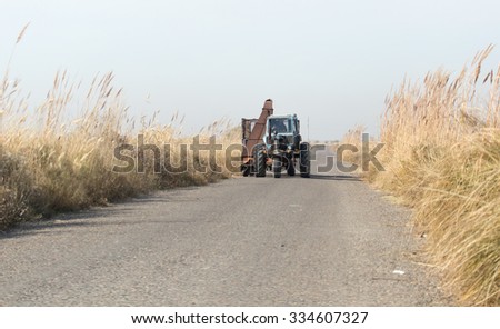 tractor on the road with a cane