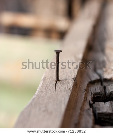 rusty nail in old wood, shallow focus