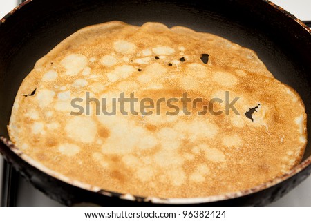 Frying a pancake cooking in a pan