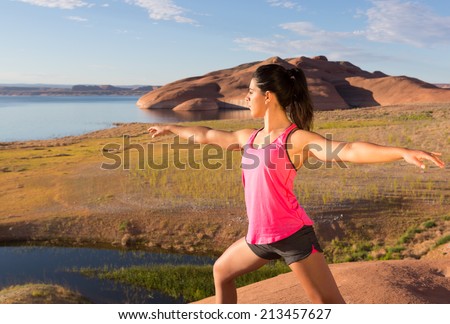 Beautiful teenage girl doing yoga at sunrise in the southern Utah desert of Lake Powell