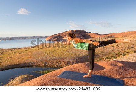 Beautiful teenage girl doing yoga at sunrise in the southern Utah desert of Lake Powell