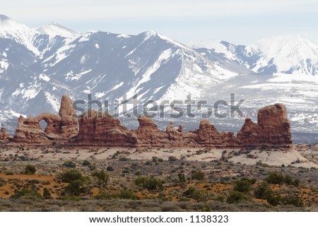 Arches landscape with snow-capped mountain backdrop