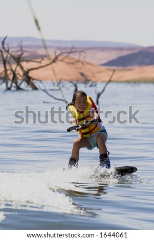 Young girl wakeboarding at Lake Powell, Glen Canyon National Recreation Area Utah USA