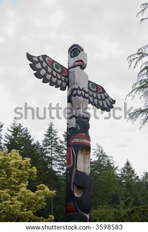 Bird carved atop a totem pole in Butchart Gardens, Victoria, British Columbia, Canada