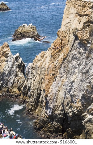 Cliff diving in Acapulco, Mexico with two cliff divers in the air