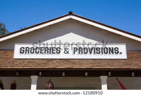 Old style grocery store sign on the roof of a store
