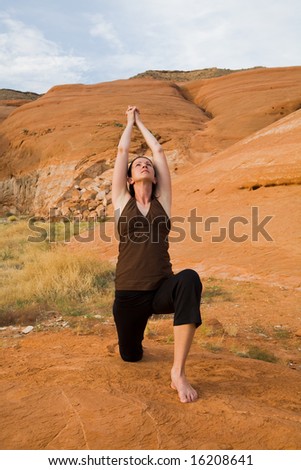 Woman doing yoga in the wilderness at sunset against a beautiful wilderness backdrop at Lake Powell, Glen Canyon National Recreation Area, Utah