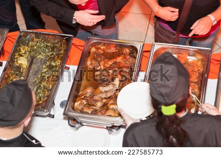 Hands of cook serving food at a catered event