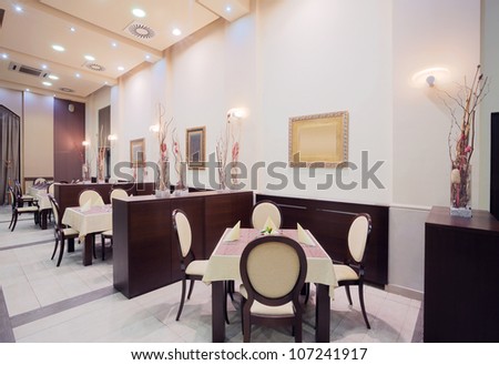 Interior of a restaurant in a hotel, during evening.