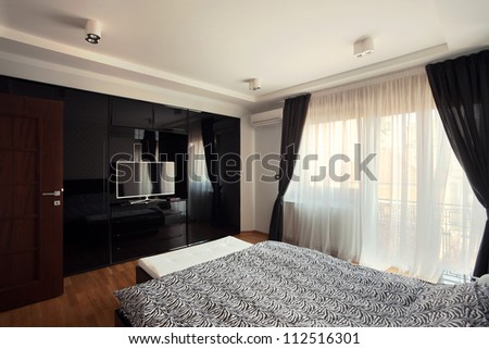Interior of a modern bedroom, black and white design.
