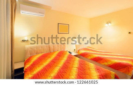 Interior of a hotel room for three persons, small but comfortable.