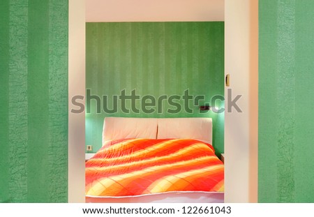 Interior of a hotel apartment, room with green wallpapers.