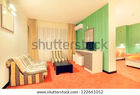 Interior of a hotel apartment, room with green wallpapers.