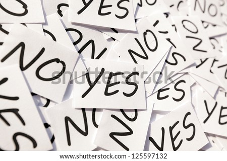 Yes\'s and No\'s written on papers on white background.