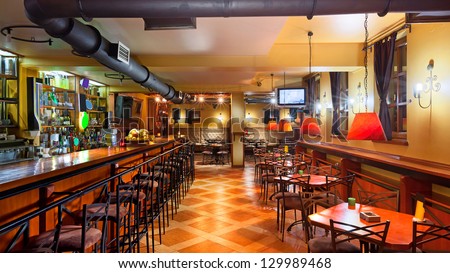 Interior Of A Modern Pub In Orange And Wooden Colors.