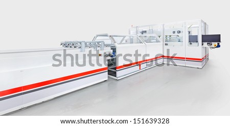Modern packaging machine, studio isolated on gray background.
