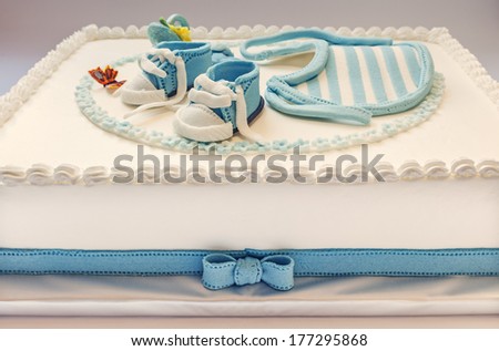 Birthday cake for baby, blue and white design, on light gray background.