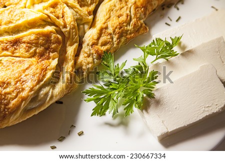 Scrambled eggs, slices of bread and cheese on white plate.