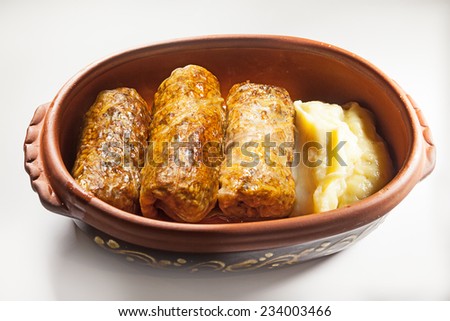Meal portion of cabbage rolls and mashed.