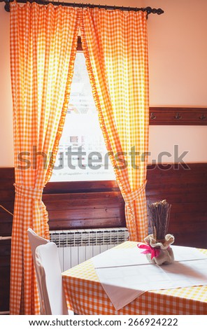 Classical restaurant interior, interesting old style curtains and furniture in white.