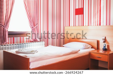 Hotel room interior, calm and peaceful atmosphere in red and white.
