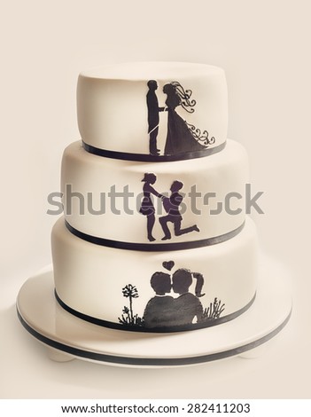 Details of a wedding cake, white sugar cream and black silhouettes.