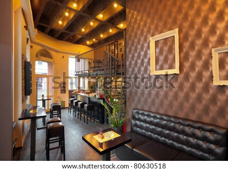 Interior of a pub with furniture during day.