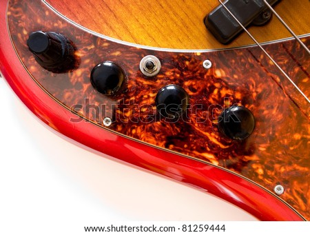 Details of bass guitar with 5 strings. Controls for volume and pick-ups .
