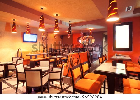 Interior of a restaurant, modern design in few colors, orange and brown.