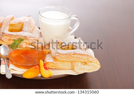 Peach cake, jam and slices with milk on plate, for breakfast