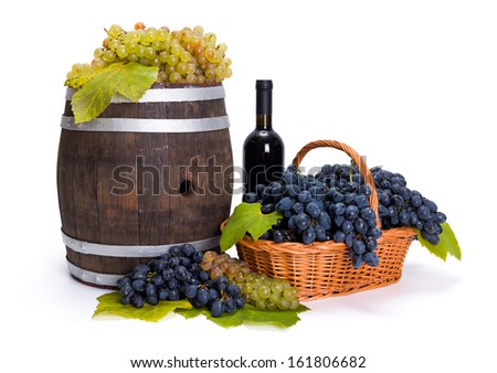 White and white grape in basket with red wine and barrel
