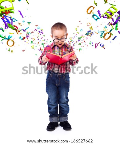 Cute little boy wearing glasses, wondering of flying letters from a tale book