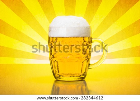 Glass mug with fresh, foamy beer on backlit yellow retro background