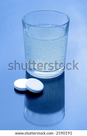Two effervescent tablets and a glass of water
