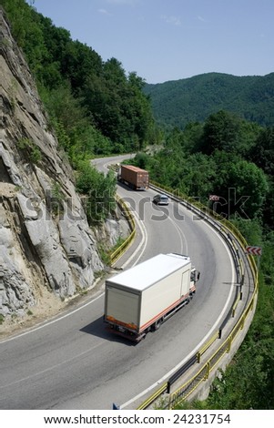 Trucks delivering cargo on mountain road