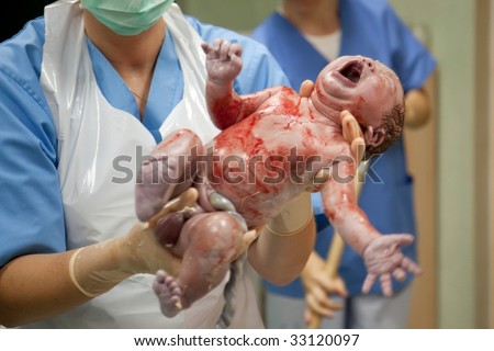 New born baby in doctor\'s hands