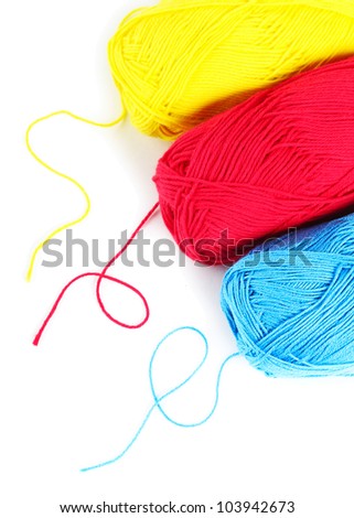 Three clews of woolen yarn over pure white background