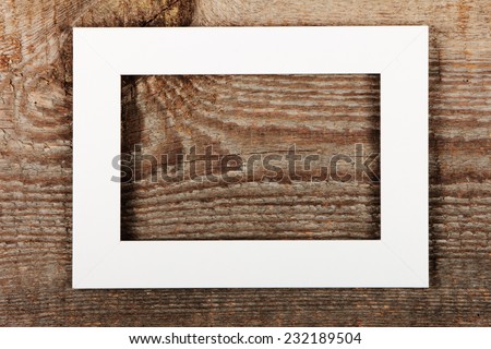 White empty frame on old wooden background