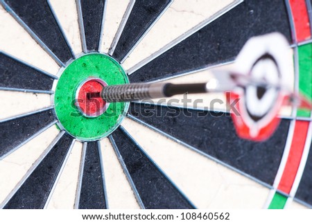 Dart in bulls eye on the target. Focus on the bulls eye.