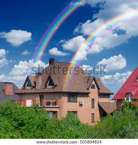 Private house on the background of a beautiful sky and a rainbow